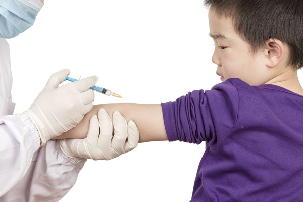 The doctor gave children vaccination needle